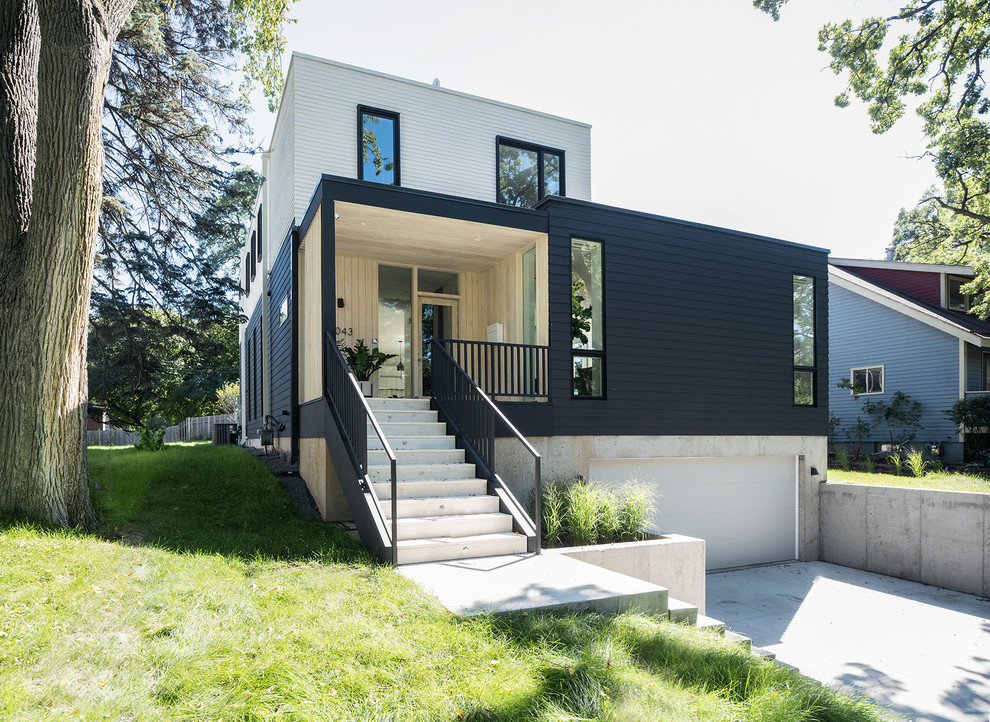 Источник вдохновения для домашнего уюта: двухэтажный, черный дом в стиле модернизм с комбинированной облицовкой и плоской крышей