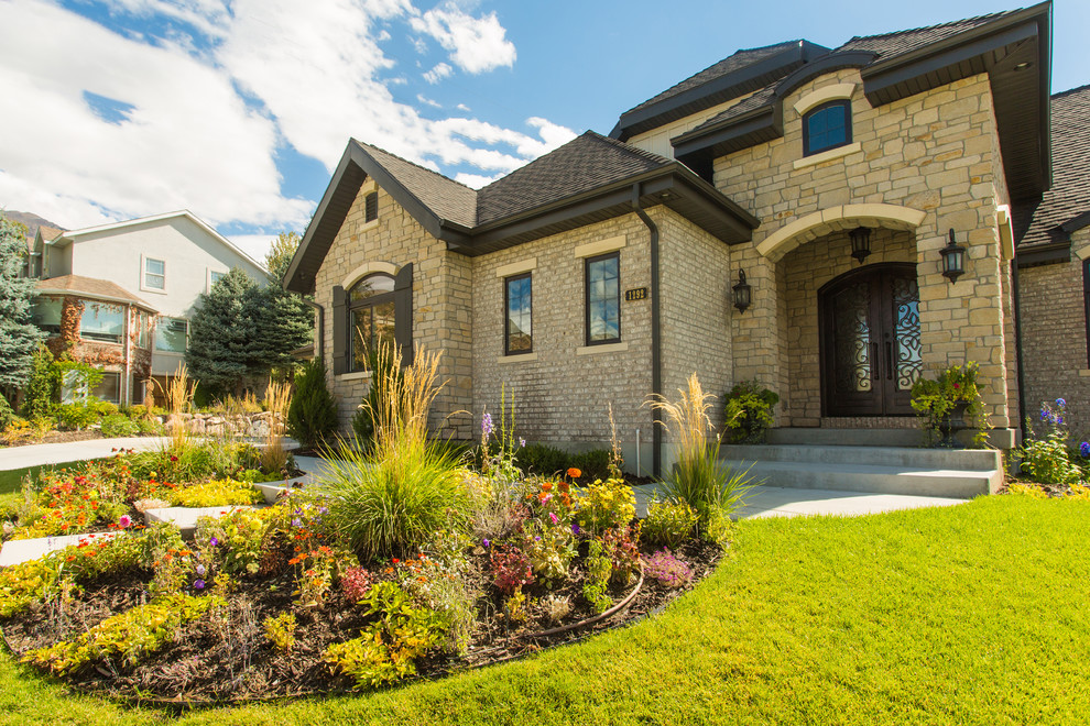 Inspiration for a large transitional multicolored two-story stone house exterior remodel in Salt Lake City with a hip roof and a shingle roof