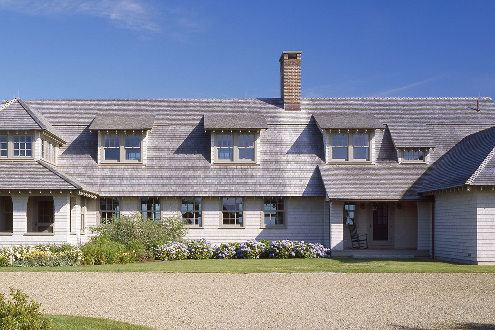 Inspiration for a large timeless gray two-story wood house exterior remodel in Boston with a gambrel roof and a shingle roof