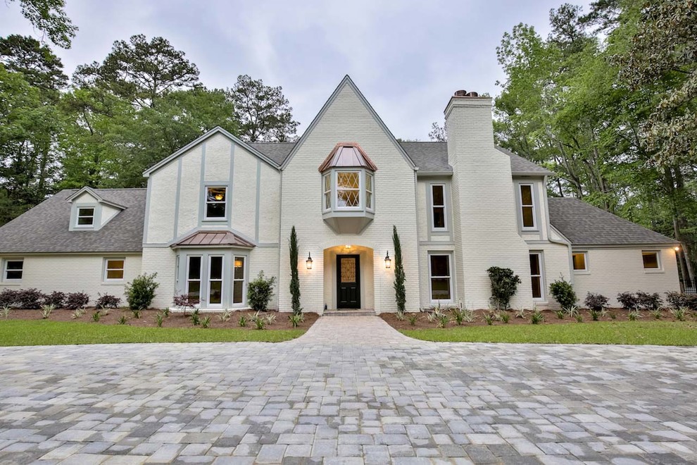 Inspiration for a large contemporary beige two-story brick gable roof remodel in Atlanta