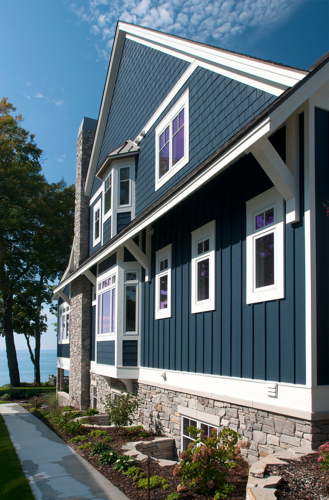 Пример оригинального дизайна: трехэтажный, синий дом среднего размера в морском стиле с облицовкой из ЦСП