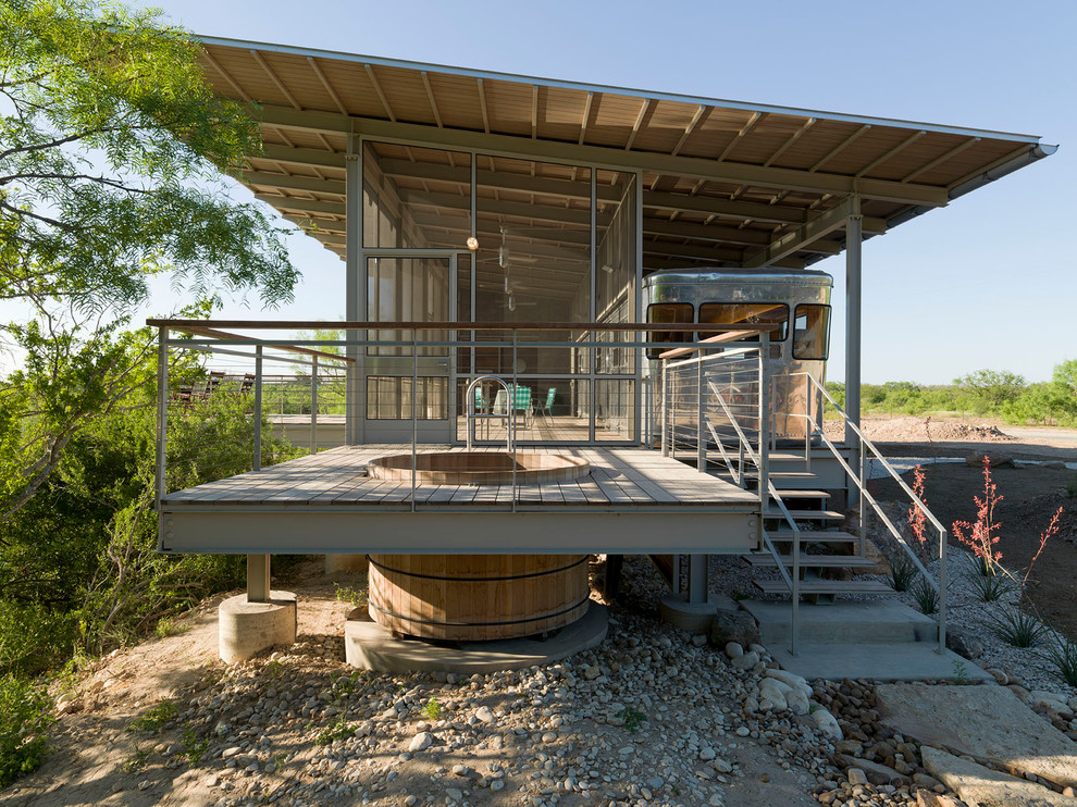 Example of a small minimalist gray two-story metal exterior home design in Austin