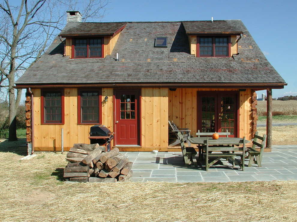 Photo of a rustic two floor house exterior in DC Metro with wood cladding.
