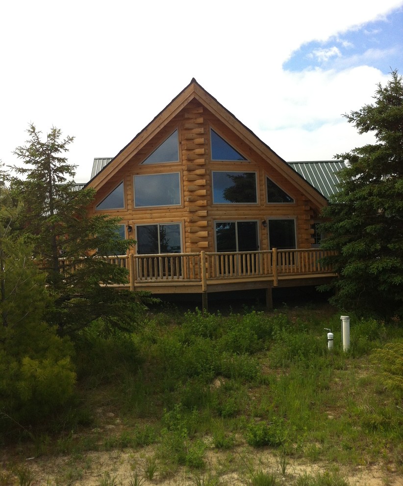 Log Home w/Large Windows Rustic Exterior Detroit by Oasis Homes