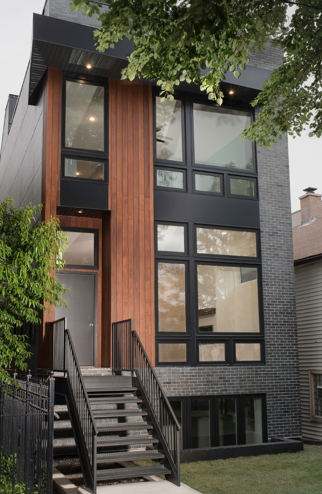 Inspiration pour une façade de maison grise design en brique de taille moyenne et à un étage.
