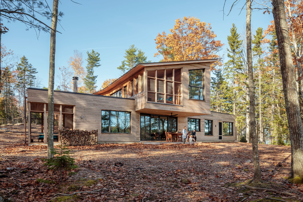 Mountain style brown two-story wood house exterior photo in Portland Maine with a shed roof