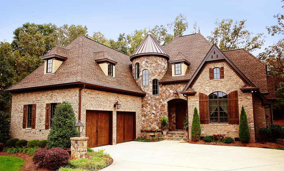 Inspiration for a timeless beige two-story mixed siding exterior home remodel in Charlotte