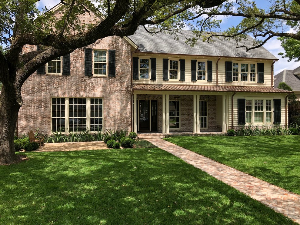 Inspiration for a mid-sized craftsman multicolored two-story brick exterior home remodel in Houston with a mixed material roof