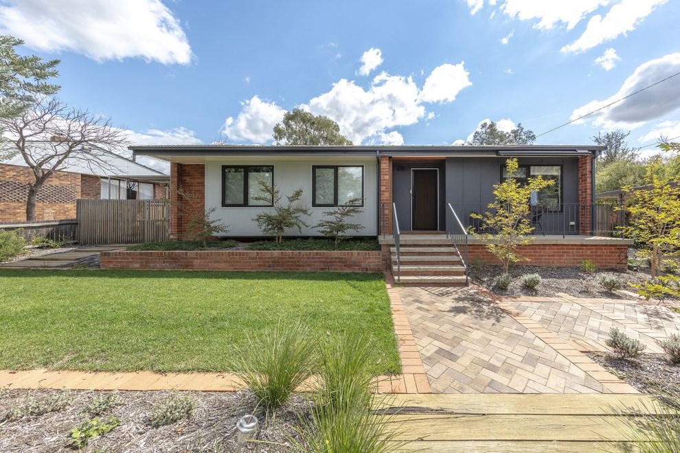 Example of a small trendy red one-story brick exterior home design in Canberra - Queanbeyan with a tile roof