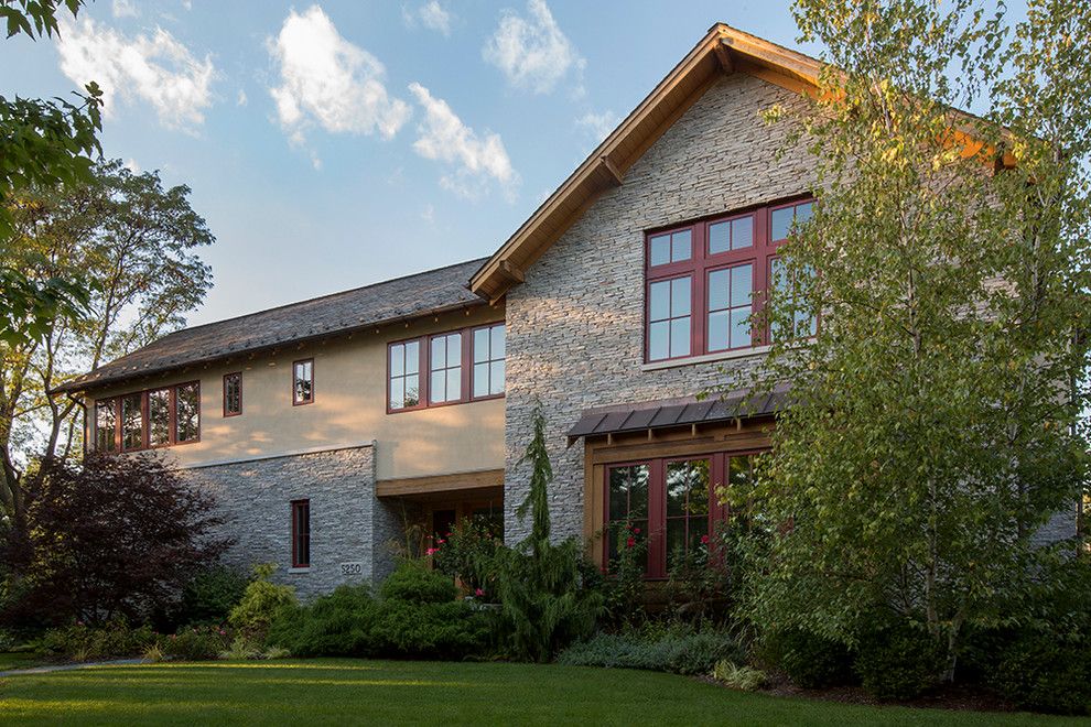Large transitional two-story stone exterior home photo in Chicago
