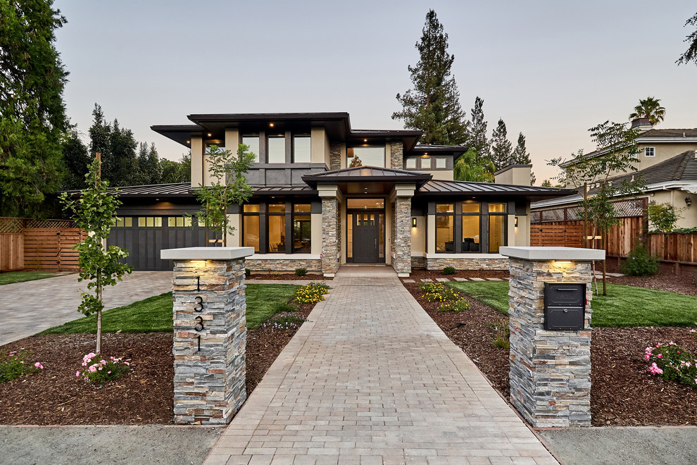 Exemple d'une façade de maison beige chic en stuc de taille moyenne et à un étage avec un toit à quatre pans et un toit en métal.