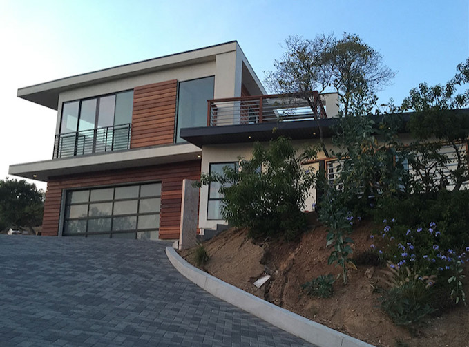 Mid-sized minimalist two-story mixed siding flat roof photo in Los Angeles