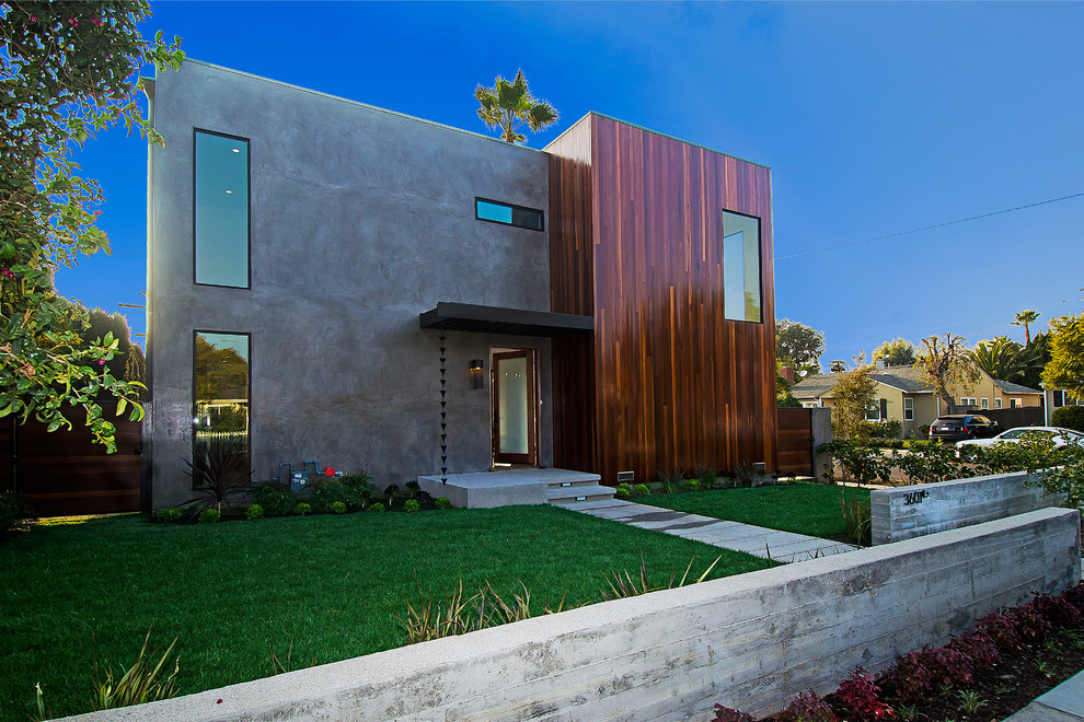 Example of a trendy two-story concrete exterior home design in Los Angeles