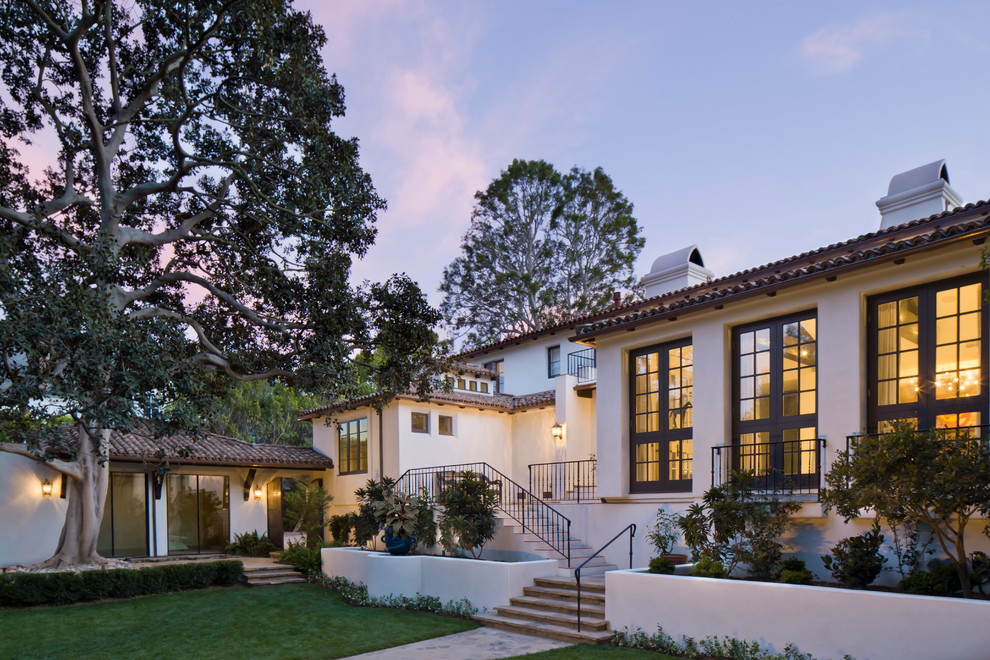Example of a tuscan white two-story stucco gable roof design in Los Angeles