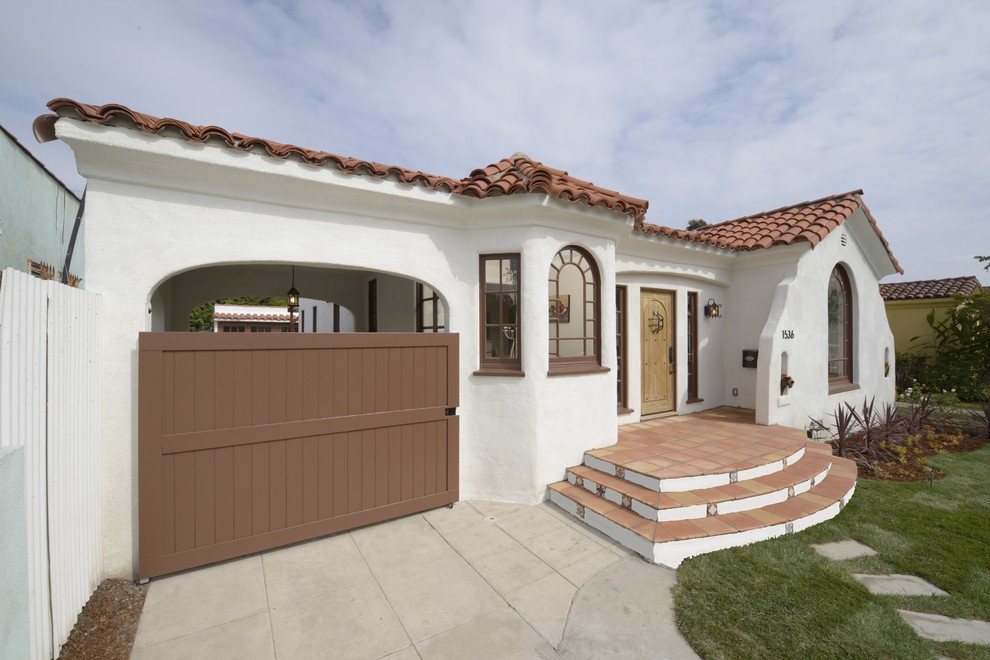 Medium sized and white mediterranean bungalow render house exterior in Los Angeles.