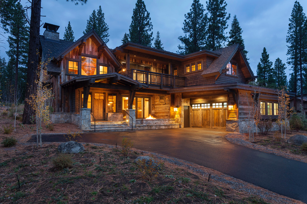 This is an example of a rustic two floor house exterior in Sacramento with wood cladding and a pitched roof.