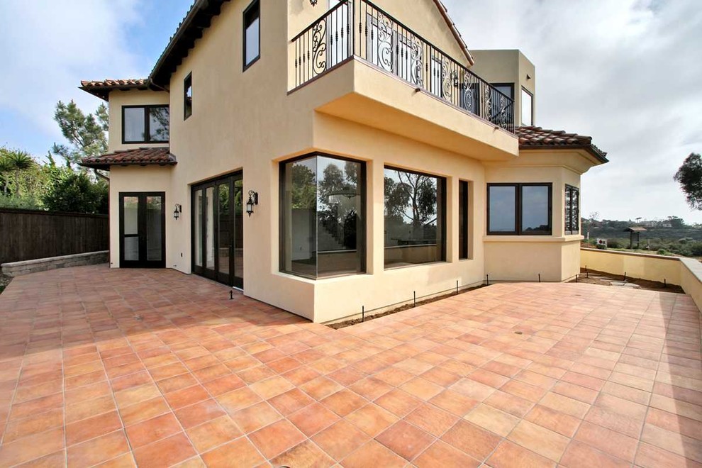 Großes, Zweistöckiges Mediterranes Einfamilienhaus mit Putzfassade, gelber Fassadenfarbe, Walmdach und Ziegeldach in San Diego