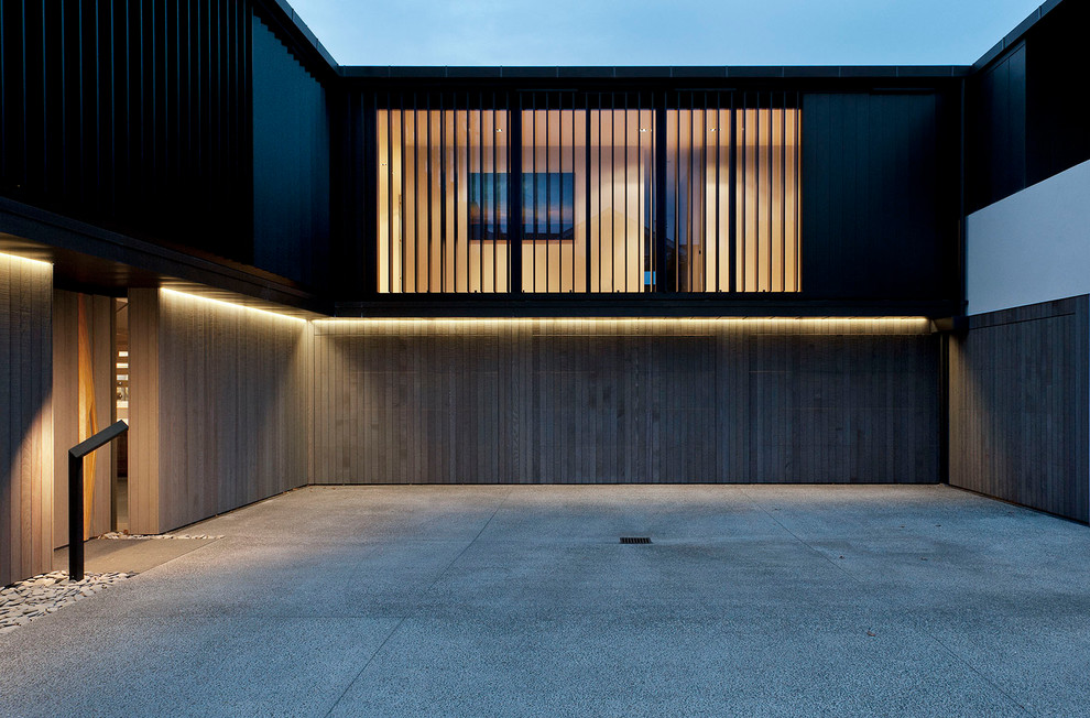 Inspiration for a contemporary two-story mixed siding exterior home remodel in Auckland