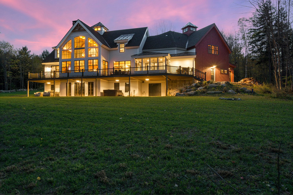 Large mountain style white two-story mixed siding exterior home photo in Boston with a shingle roof