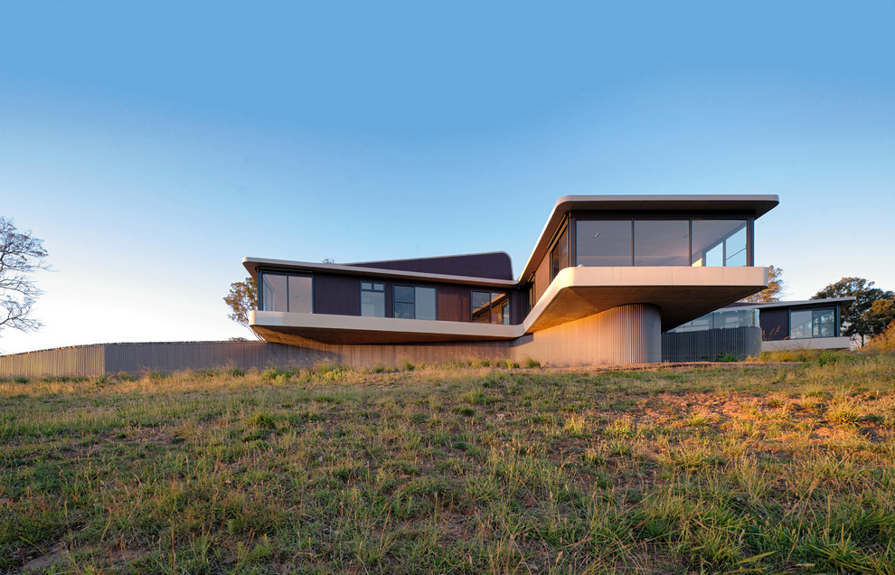 Trendy beige two-story glass exterior home photo in Sydney
