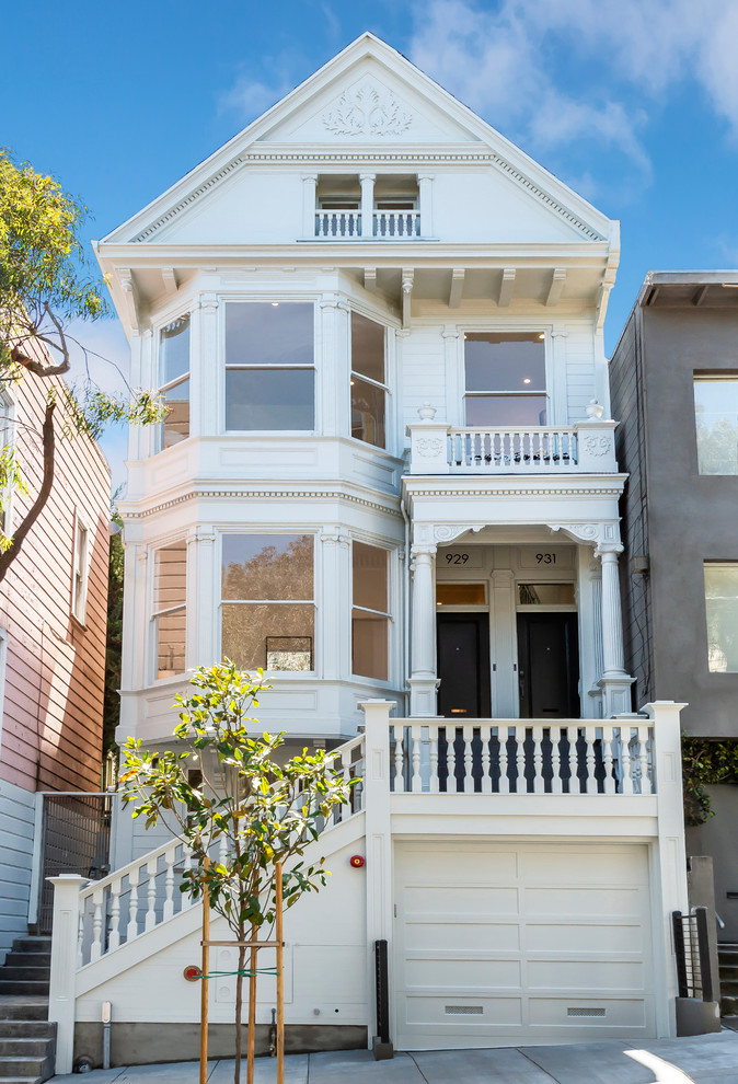 Photo of a medium sized and white victorian detached house in San Francisco with three floors, wood cladding, a pitched roof and a shingle roof.