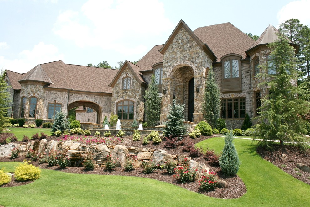 Design ideas for an expansive and brown traditional two floor brick house exterior in Atlanta.