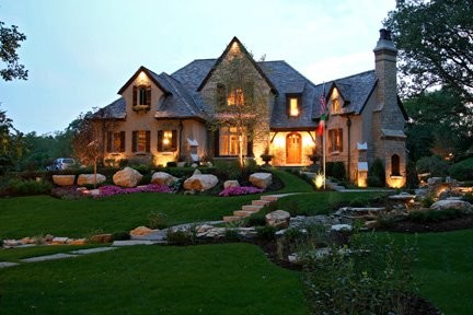 Example of a large classic beige two-story stone exterior home design in Chicago with a hip roof