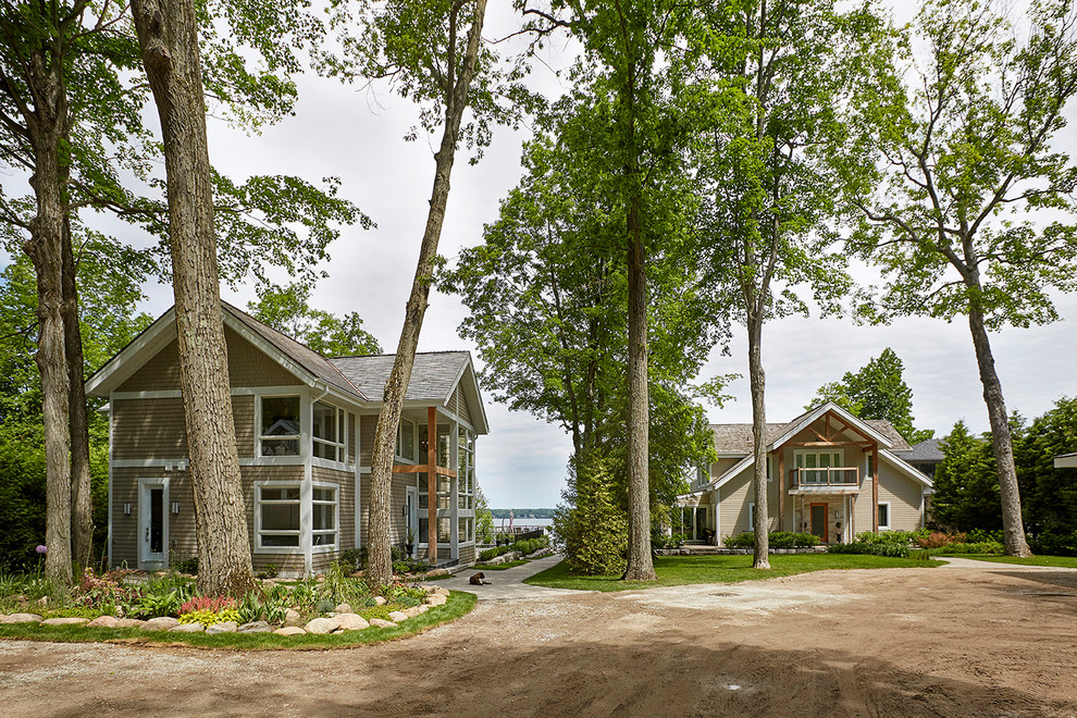 Imagen de fachada de casa gris actual extra grande de dos plantas con revestimiento de madera y tejado a dos aguas