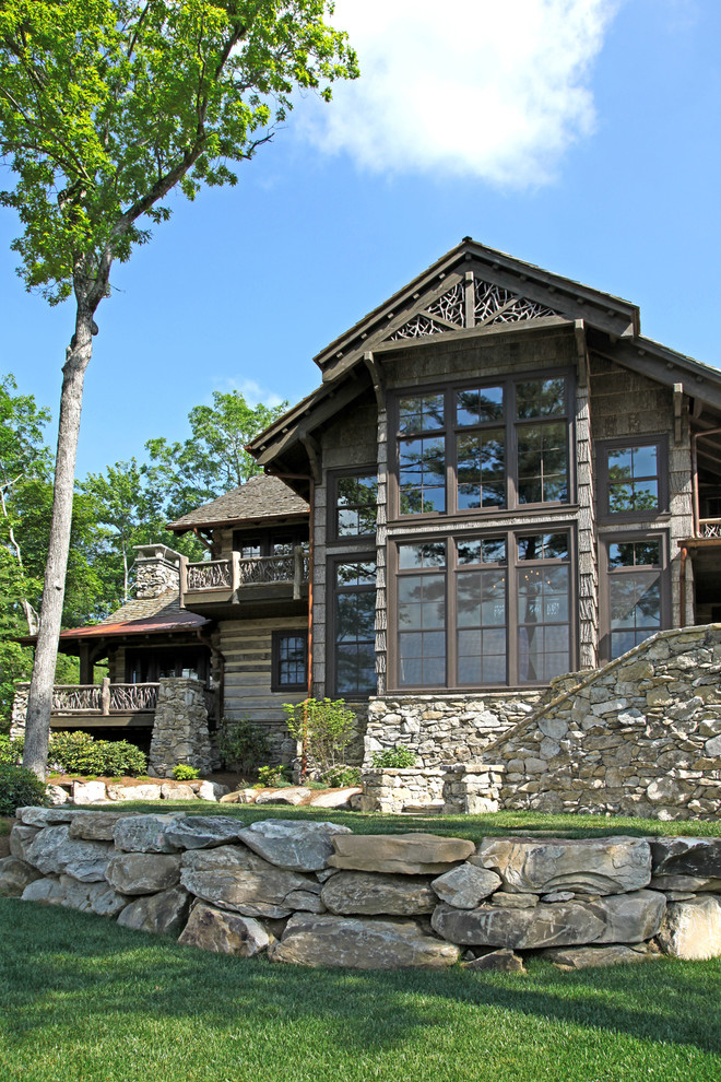 Example of a large mountain style brown two-story wood exterior home design in Other