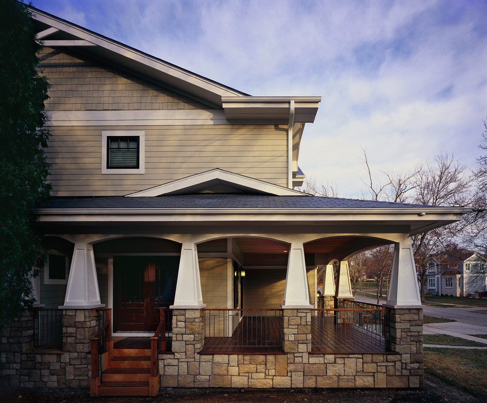 Example of a mid-sized arts and crafts beige two-story mixed siding and clapboard exterior home design in Chicago with a shingle roof and a gray roof