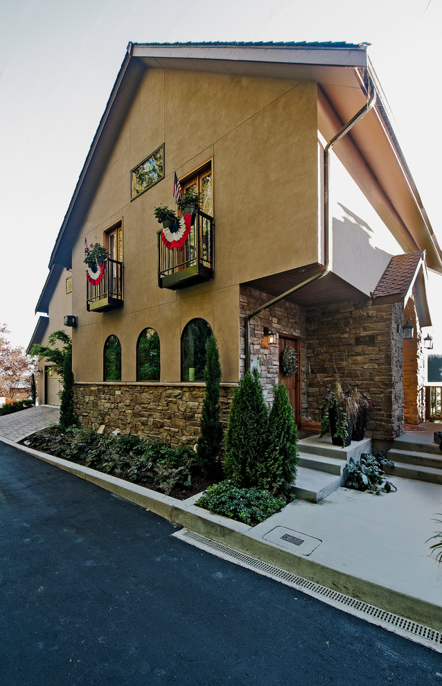 Стильный дизайн: трехэтажный, разноцветный дом в классическом стиле с комбинированной облицовкой и двускатной крышей - последний тренд