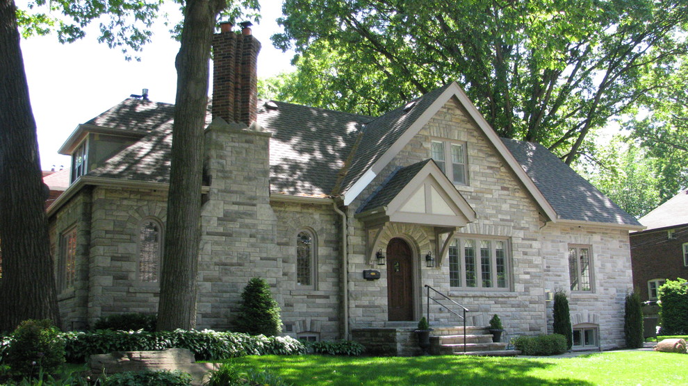Example of a large classic gray two-story stone exterior home design in Toronto