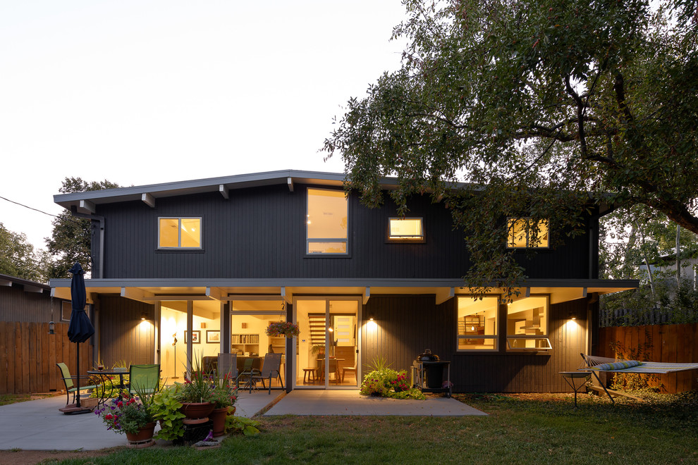 Idées déco pour une façade de maison grise rétro en bois de taille moyenne et à niveaux décalés.