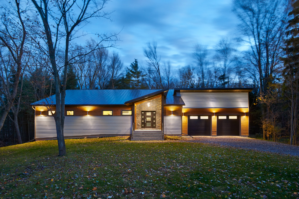 Large trendy gray one-story metal exterior home photo in Toronto with a shed roof