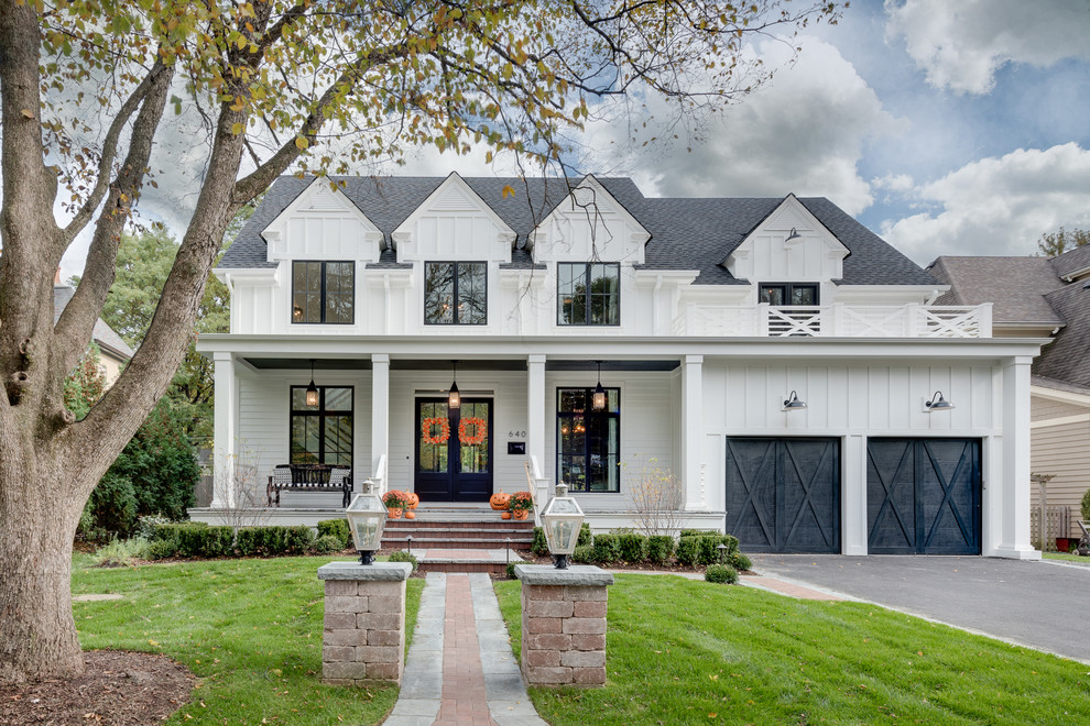 Inspiration for a large farmhouse white two-story wood house exterior remodel in Chicago with a shingle roof