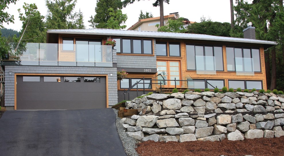 This is an example of a traditional split-level house exterior in Toronto with wood cladding.