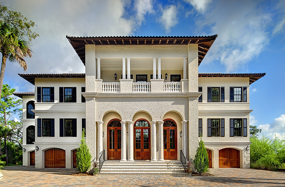 Inspiration for a mediterranean house exterior in Charleston with three floors.