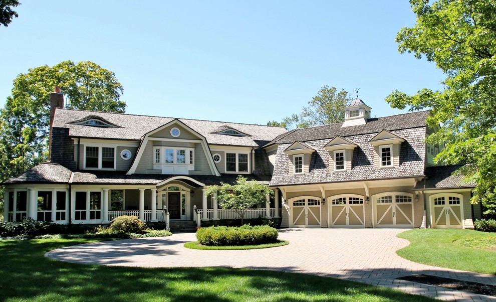Example of a large ornate gray three-story wood exterior home design in New York