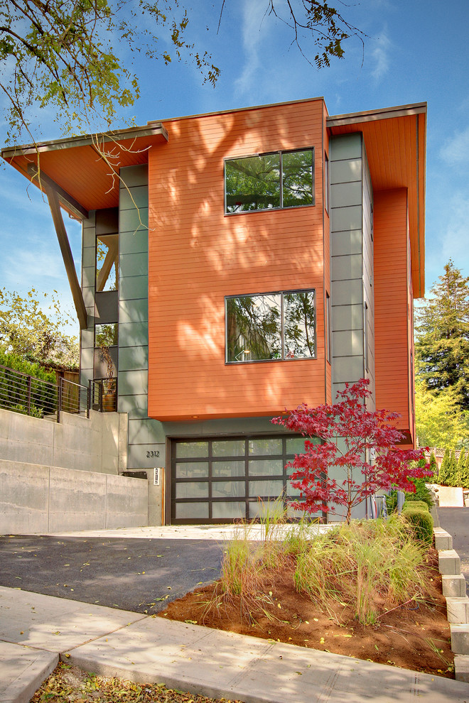 Contemporary house exterior in Seattle with three floors and an orange house.