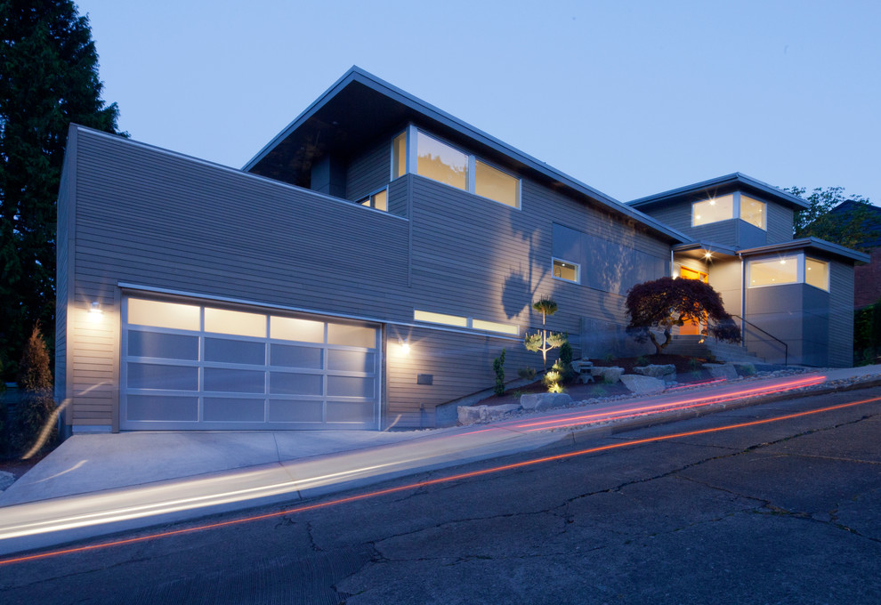 This is an example of a gey contemporary split-level house exterior in Seattle with mixed cladding.