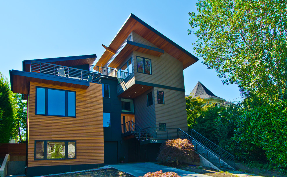 Идея дизайна: большой, трехэтажный, деревянный, зеленый дом в стиле модернизм с односкатной крышей