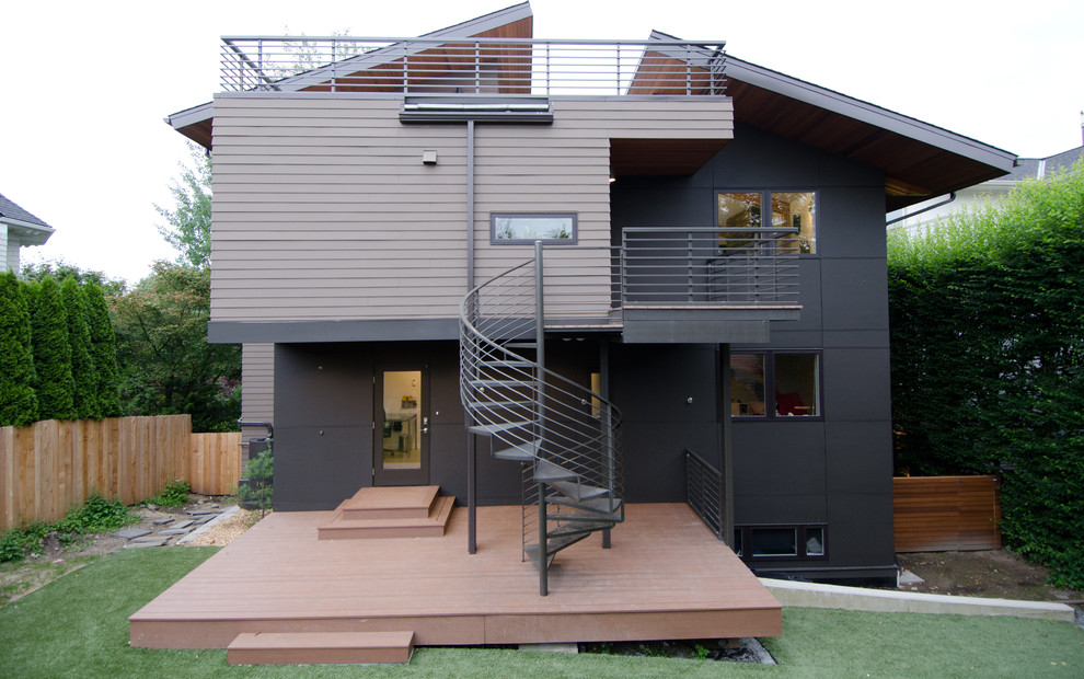 Large and black modern house exterior in Seattle with three floors, wood cladding and a lean-to roof.