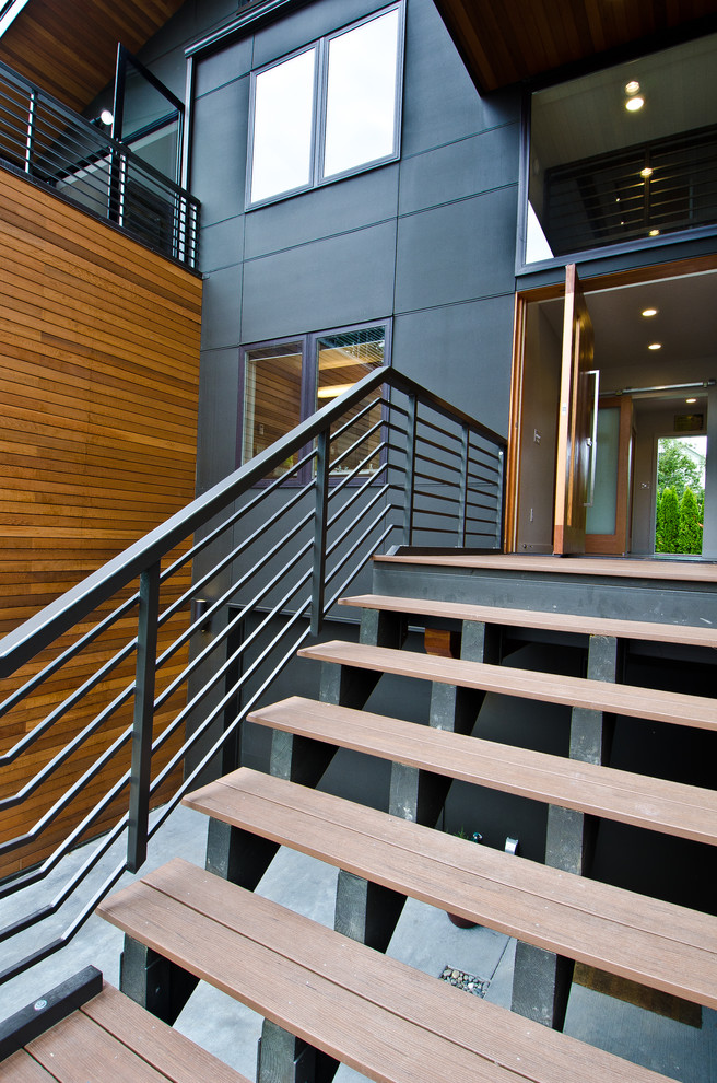 Inspiration for a large and brown modern house exterior in Seattle with three floors, wood cladding and a lean-to roof.