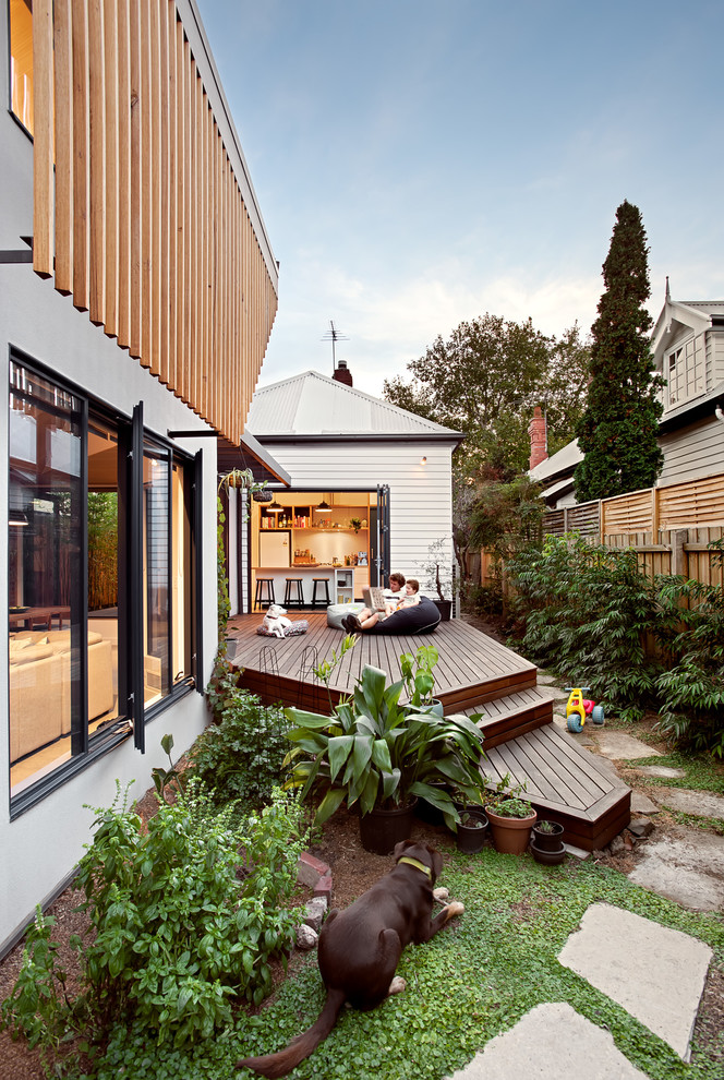 This is an example of a medium sized and white contemporary bungalow render detached house in Melbourne with a hip roof and a metal roof.