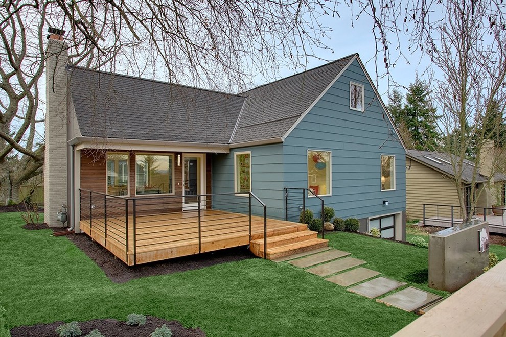 This is an example of a blue traditional bungalow house exterior in Seattle with wood cladding.