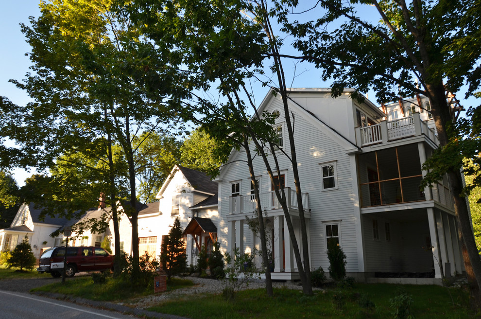 Example of a large beach style white three-story concrete fiberboard gable roof design in Portland Maine