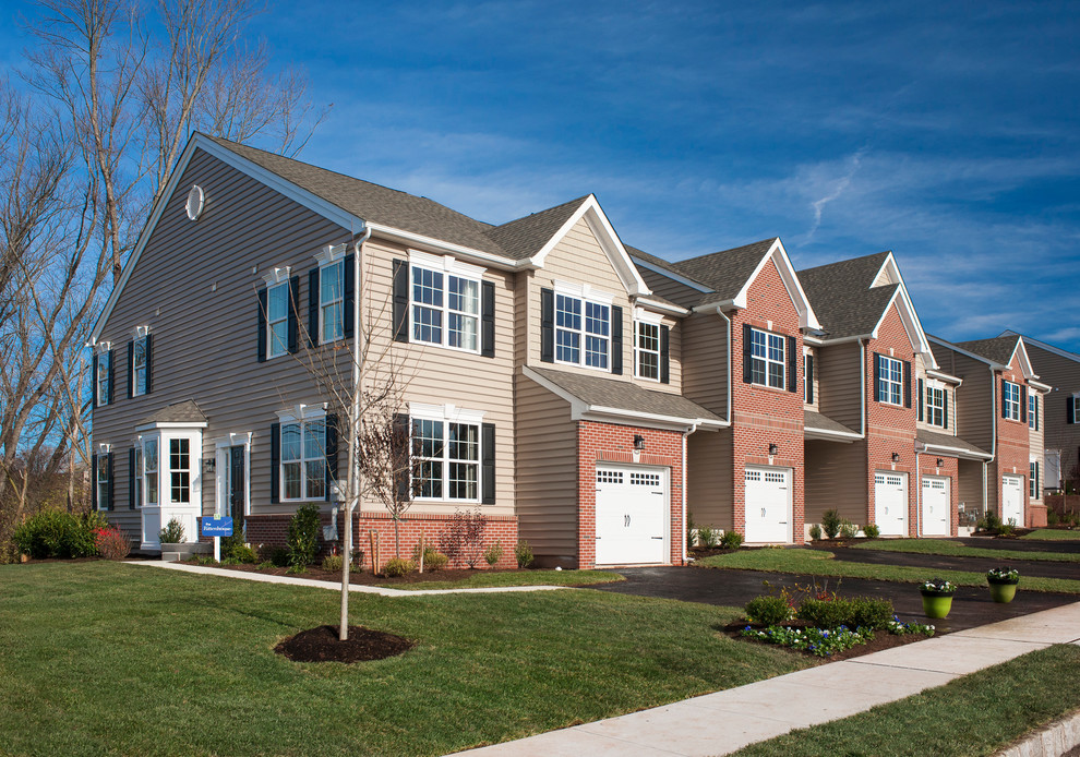 Mid-sized transitional beige two-story brick gable roof photo in Philadelphia