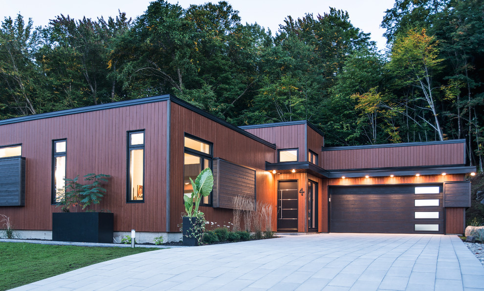 Mid-sized trendy brown two-story wood exterior home photo in Montreal