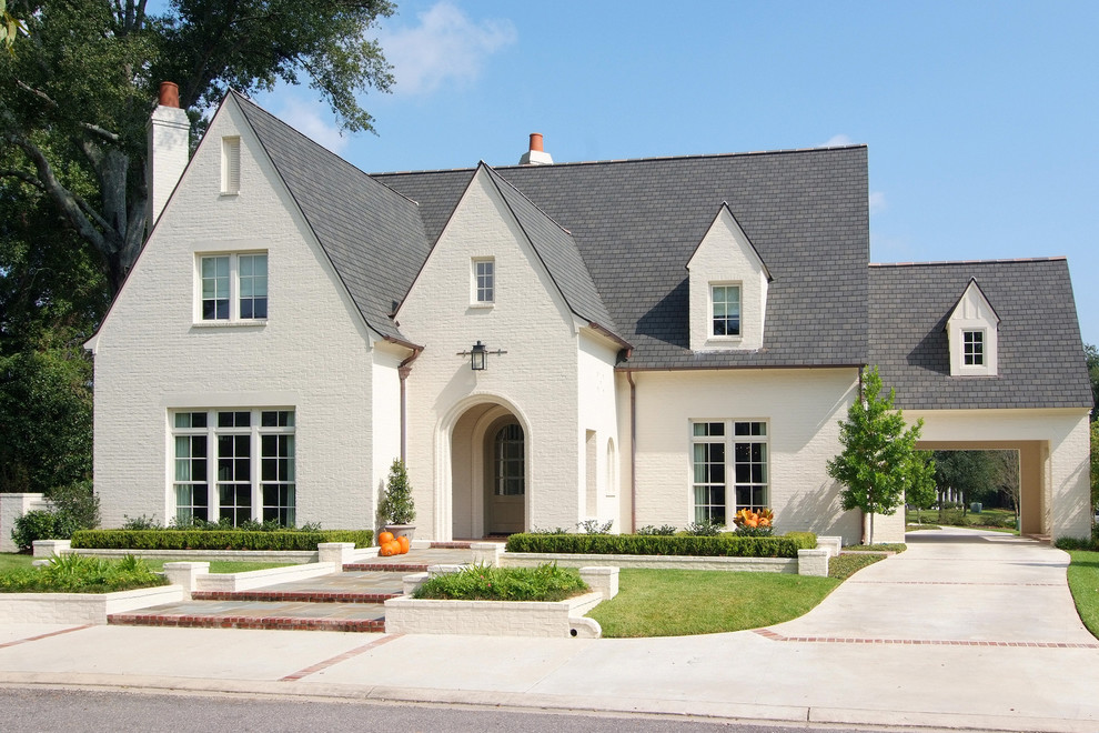 Example of a large classic two-story brick gable roof design in New Orleans