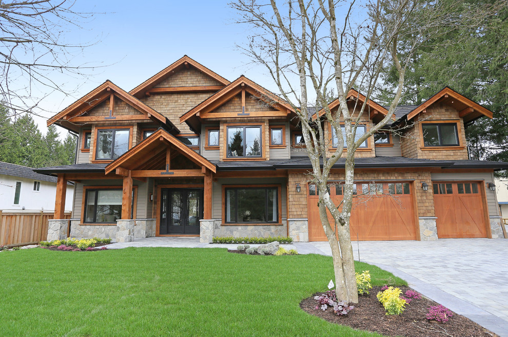 Large craftsman brown two-story mixed siding exterior home idea in Vancouver with a shingle roof
